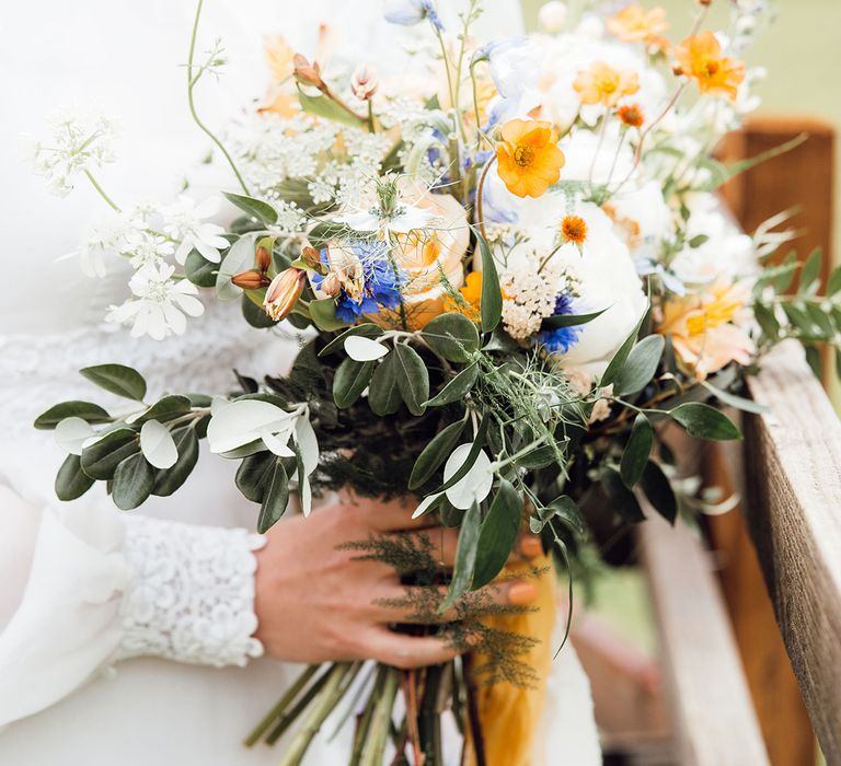 Pretty orange, blue, and white wedding bouquet with wildflowers 