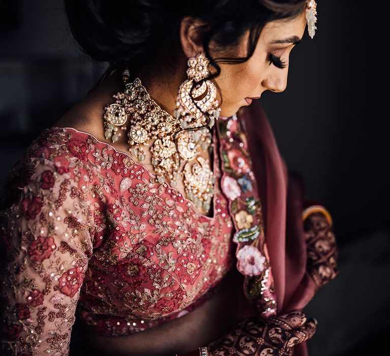 Indian bride wears intricately embellished lehenga complete with floral stitching 