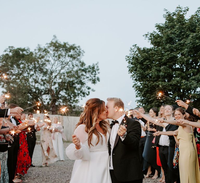 Bride & groom during sparkler exit outdoors at Botley Hill Barn