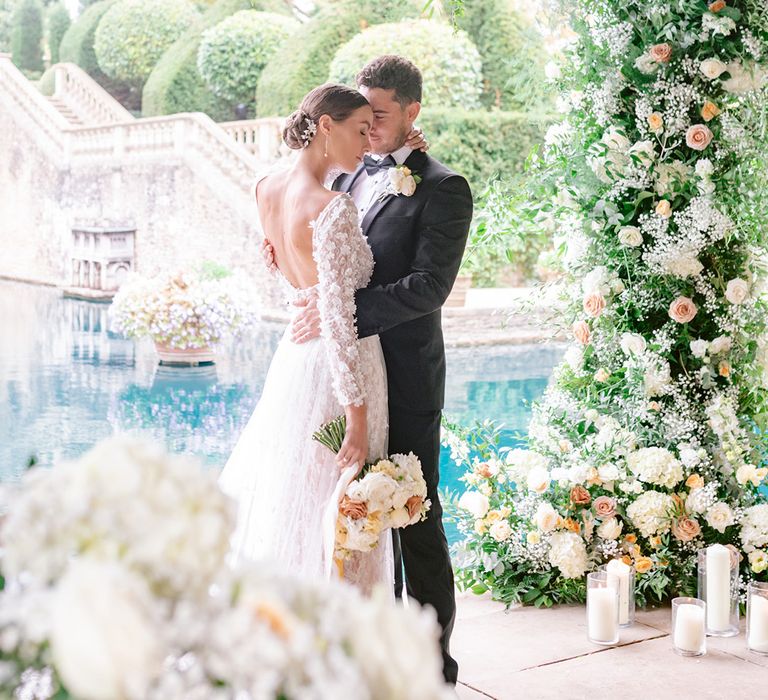 Bride in a backless flower applique wedding dress with the groom in black tie for Euridge Manor wedding 