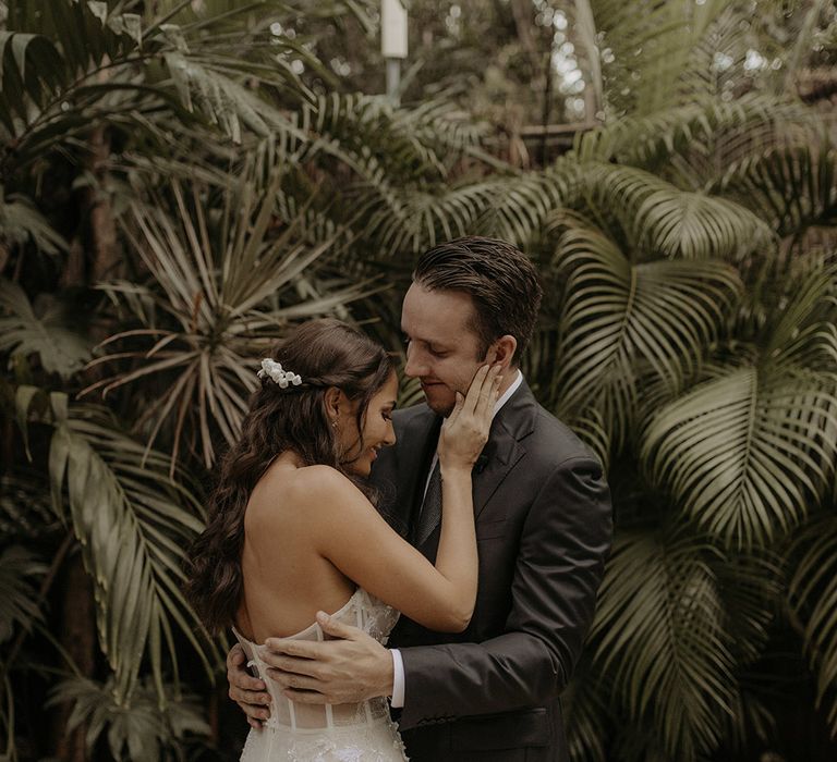 Bride & groom kiss after first look moment outdoors in Tulum 