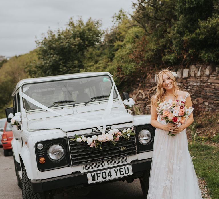 White wedding truck wedding transport with the bride standing in front of it in a tulle Anna Kara wedding dress 