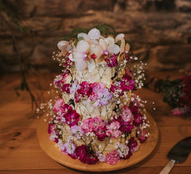 wedding cake decorated with wildflowers 