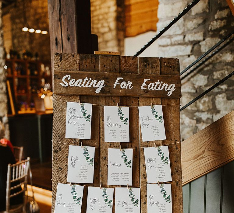 DIY wooden pallet wedding seating chart idea made with stencils 