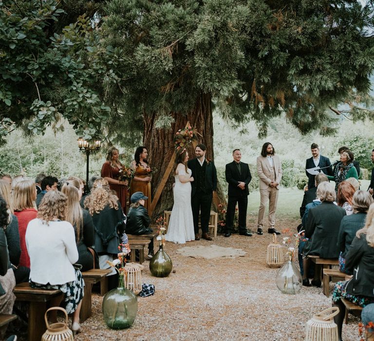 bespoke wedding ceremony under a Sequoia tree at L'Orangerie du Manoir wedding venue in France