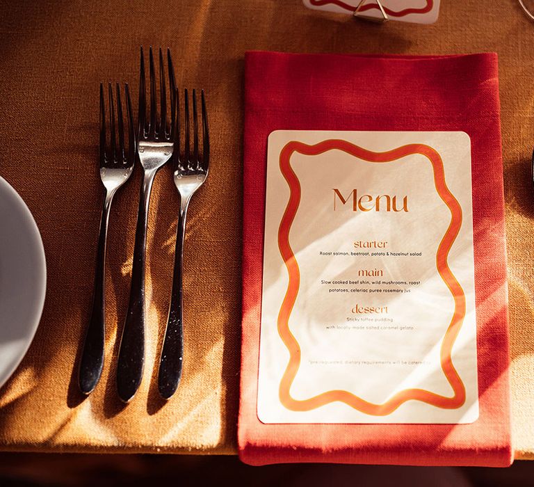 Wavy pattern wedding menu on bright coloured napkin  