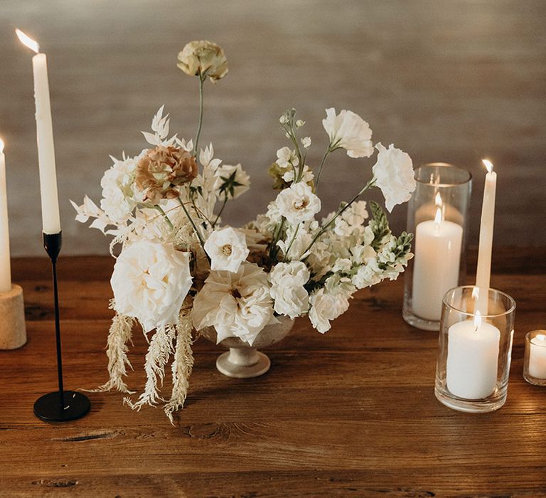 modern white wedding flowers and pillar and taper candles for Mexican wedding 