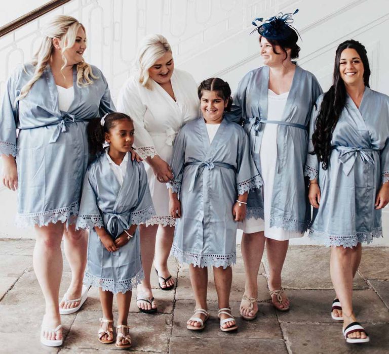 Bridal party wearing dusky blue getting ready robes and white bridal getting ready robe at Brickhouse Vineyard Devon wedding