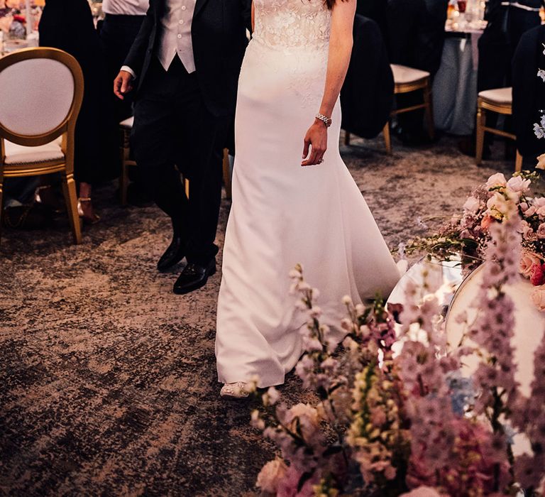 The bride and groom enter their wedding reception together 