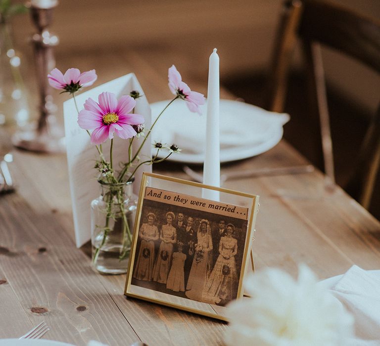 Pink cosmos flowers in bud vase decorating the wedding tablescape 