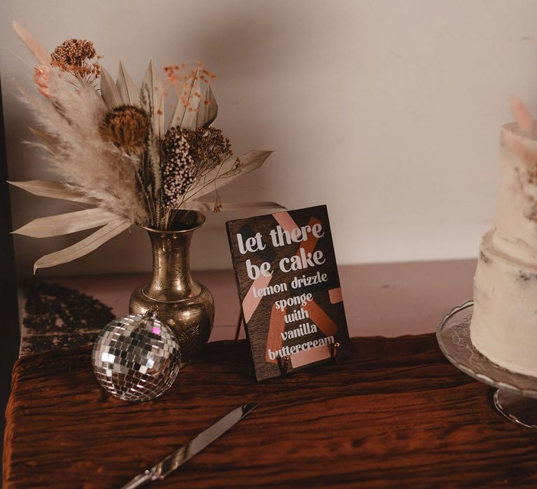 Wedding cake sign in brown neutral tones describing the flavours of the wedding cake 