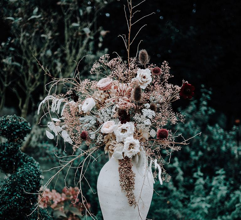 Autumnal winter wedding flowers with neutral flowers including dried flowers and twigs for the seasonal effect 