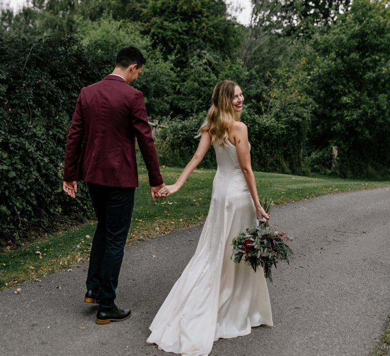 Bride and groom holding hands at 2020 wedding