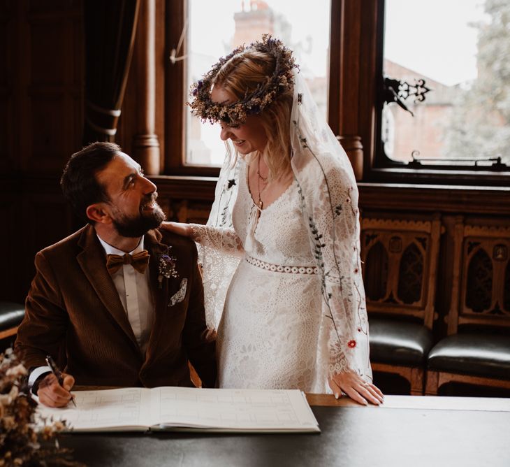 Bride and groom signing the register at 2020 wedding 