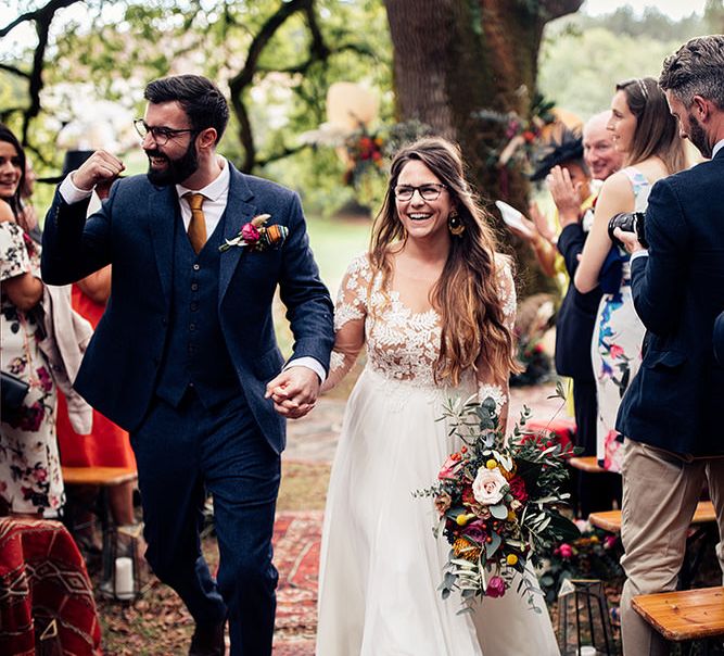 Confetti moment for bride and groom at wedding