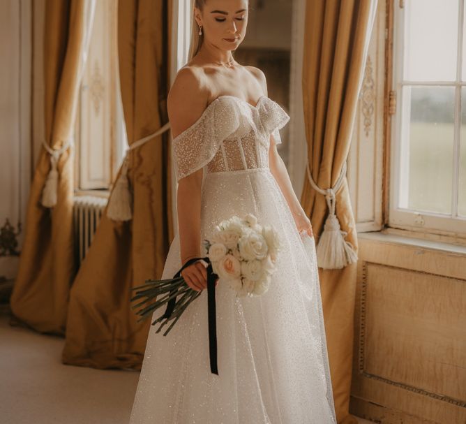 Bride on wedding morning in embellished wedding dress