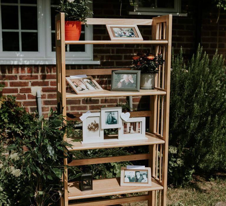 Family photographs decorating the outdoor wedding reception at home