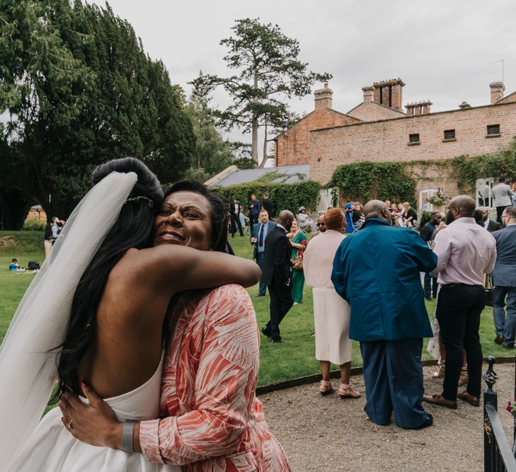 Bride hugging her wedding guests at Garthmyl Hall wedding 