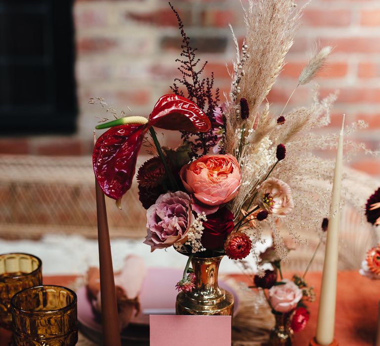 Pink & red floral bouquets in brass vase