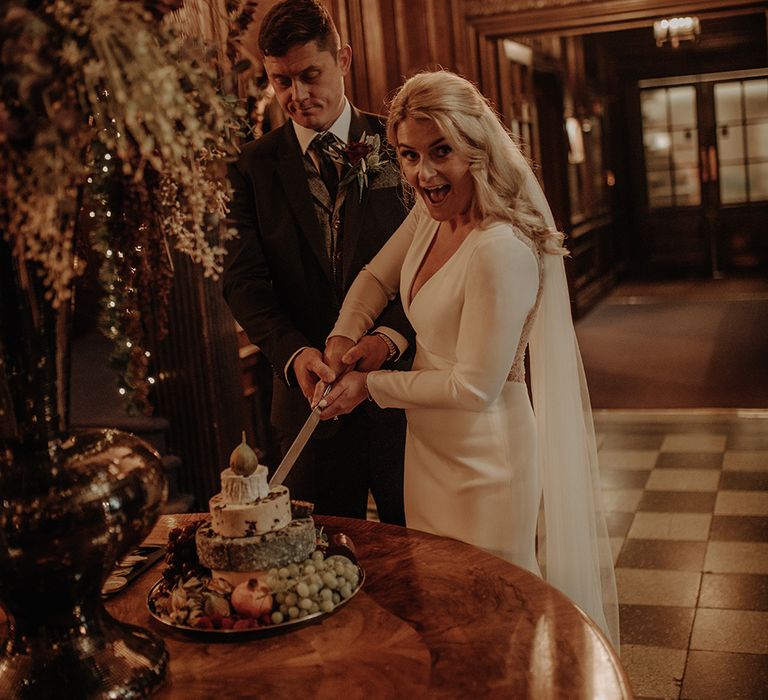 Bride and groom cut their cheese wedding cake