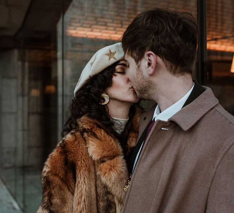 Bride wears a coat for Winter wedding