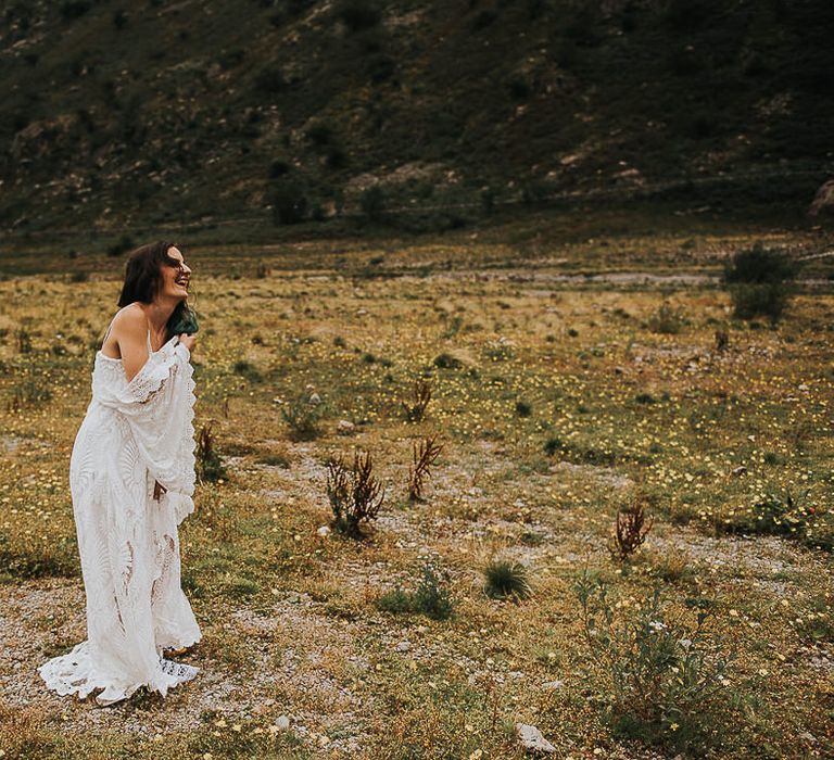 Brown haired bride laughs in the countryside outdoors