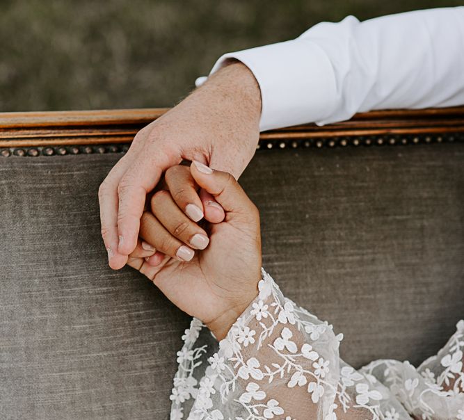 Bride & groom hold hands with bride wearing neutral tone nail varnish