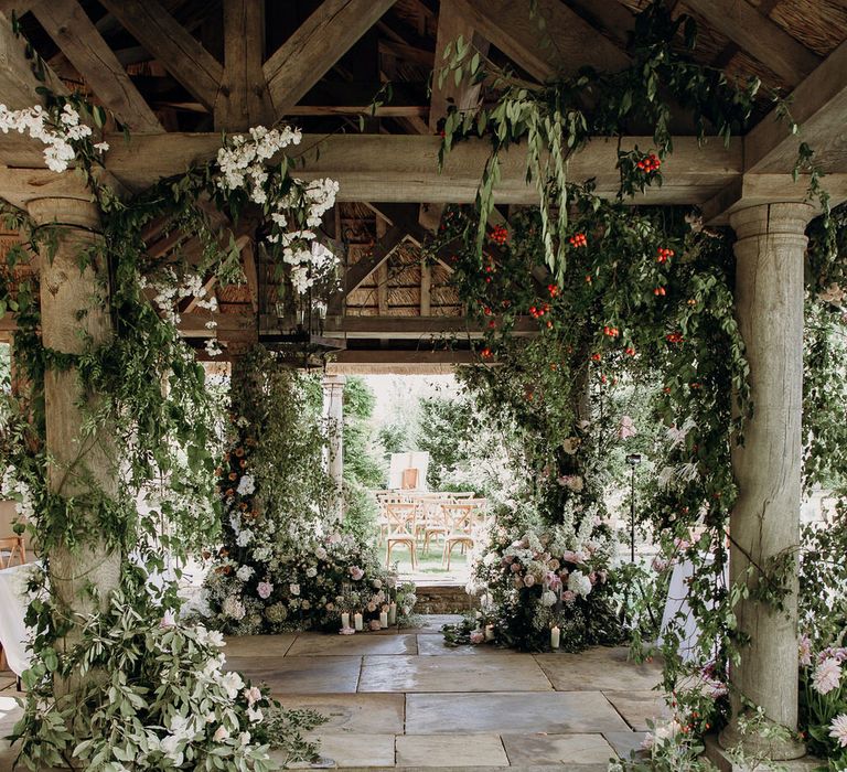 Pink and white floral installation at Euridge Manor Orangery wedding with roses, dahlias and hydrangeas and floral row boat