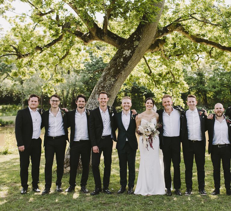 Bride & groom stand with the groomsmen