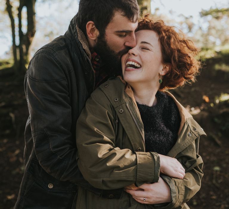 Man wraps arms around his future bride during engagement session