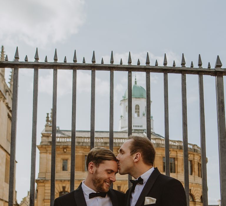 Grooms stand outside Oxford Town Hall after wedding ceremony