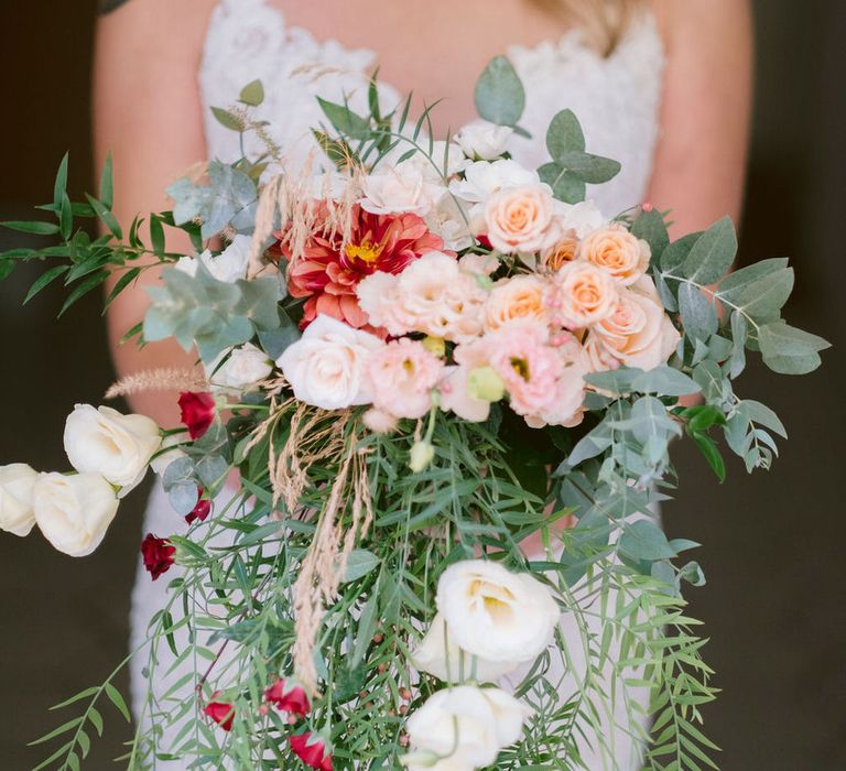 Floral wedding bouquet of roses, carnations and eucalyptus leaves