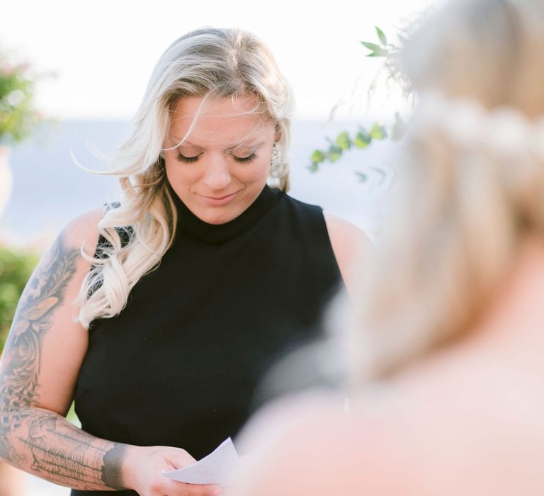 The brides reading their vows at their wedding ceremony at Hotel Marincanto