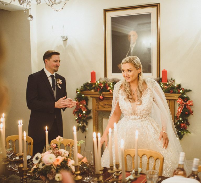 Beautiful bride in a Enzoani wedding dress and bespoke bridal cape at Goldsborough Hall wedding reception