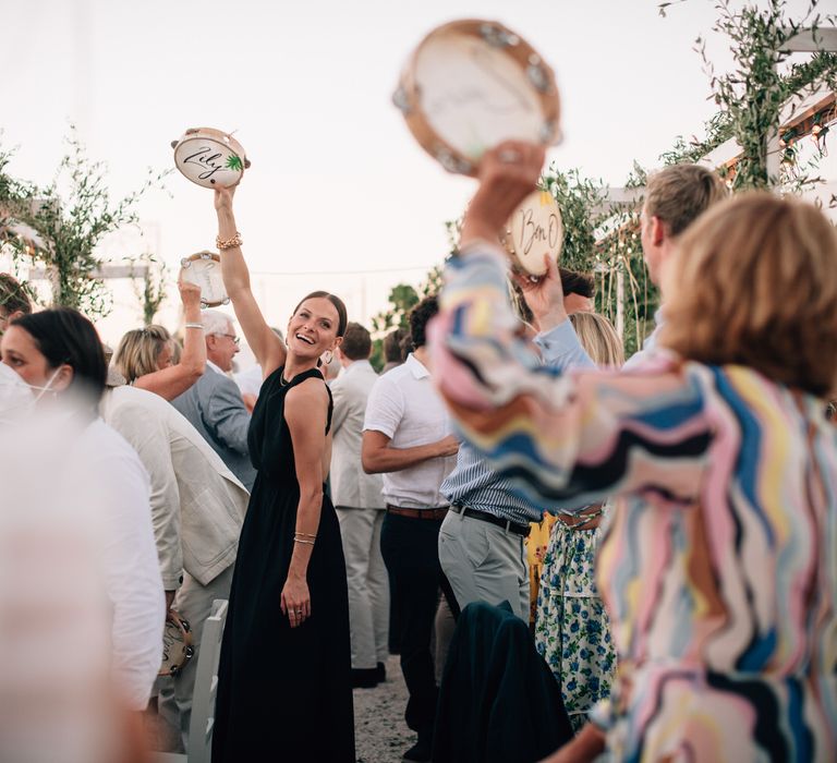 The guests celebrating and cheering with personalised tambourines