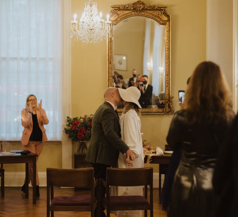 Bride & groom kiss at Chelsea Town Hall during their wedding ceremony