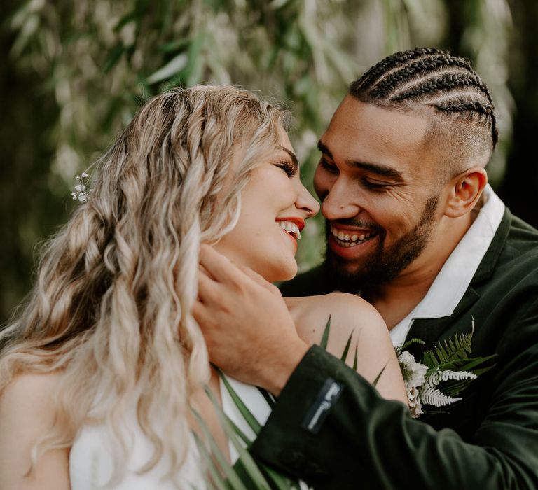 Bride and groom in white and green for tropical wedding theme