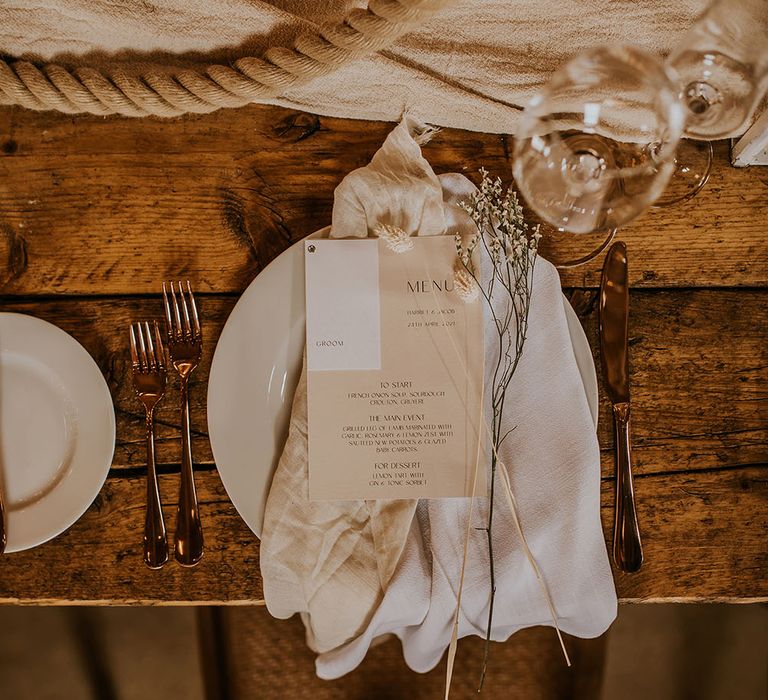 Place setting with linen napkin and beige menu card 