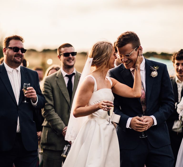 Bride and groom share a moment during wedding speeches