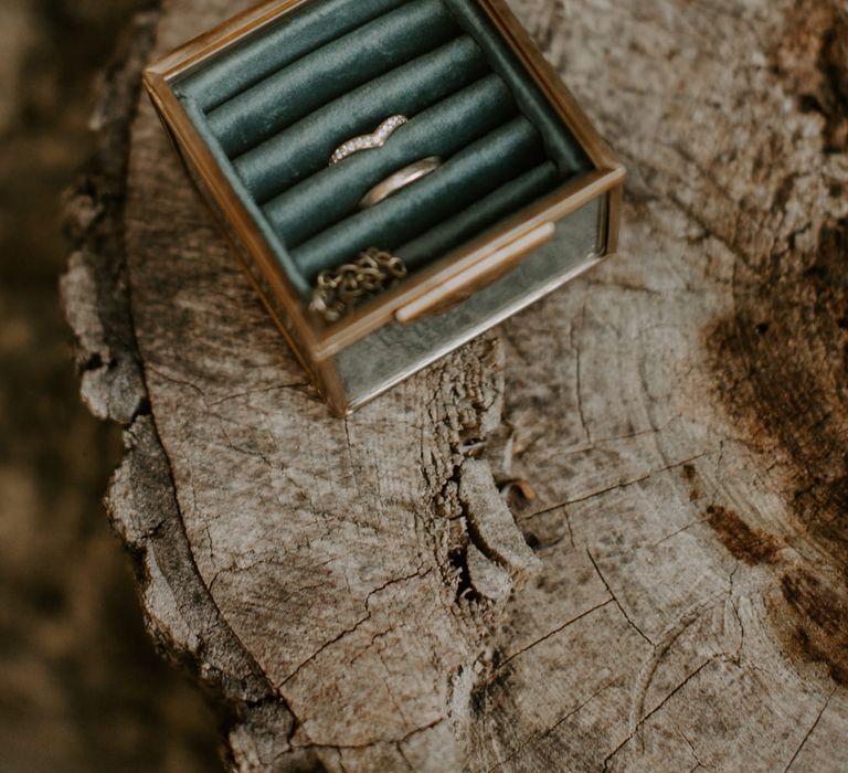 Wedding rings with glass box with green velvet cushion 