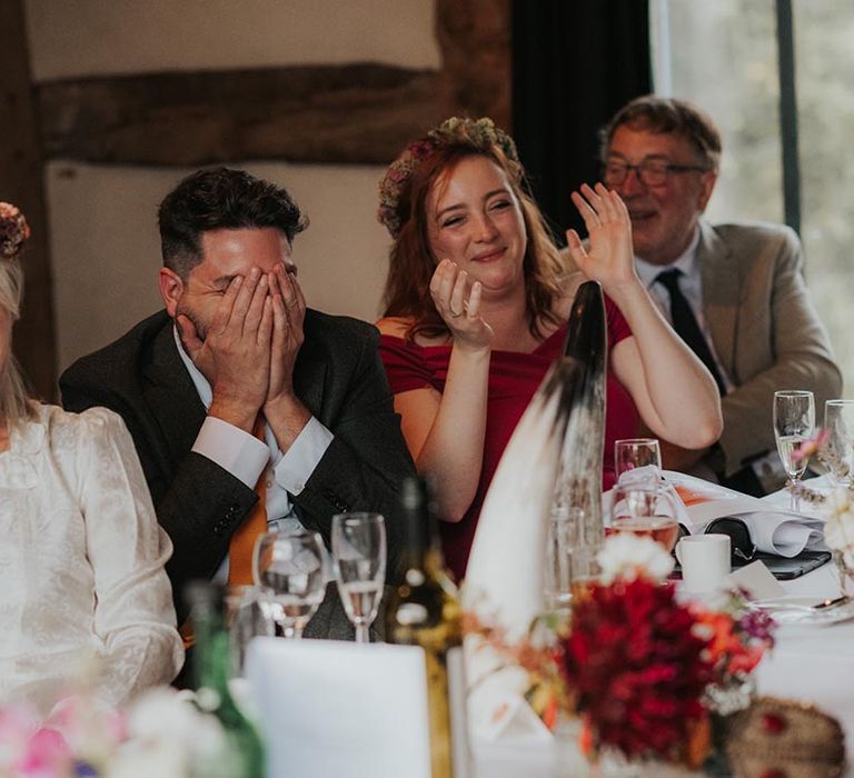 Bride and groom enjoy wedding speeches