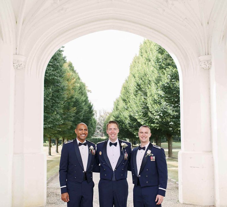 Groom stands with his groomsmen outdoors