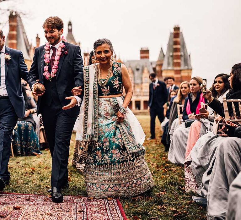 Mother of the bride wears teal sequinned dress at Indian wedding