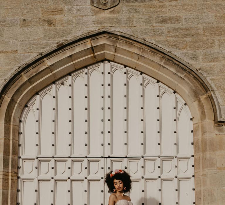 Black bride in a pink princess tulle wedding skirt and embroidered corset top 