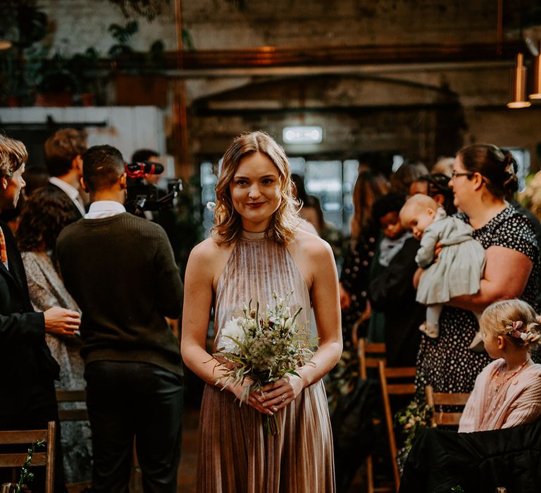 Bridesmaid walks down the aisle 