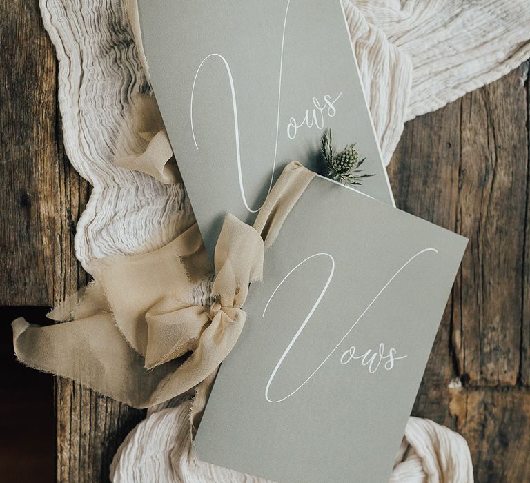 His and hers wedding vow books on a linen table runner 