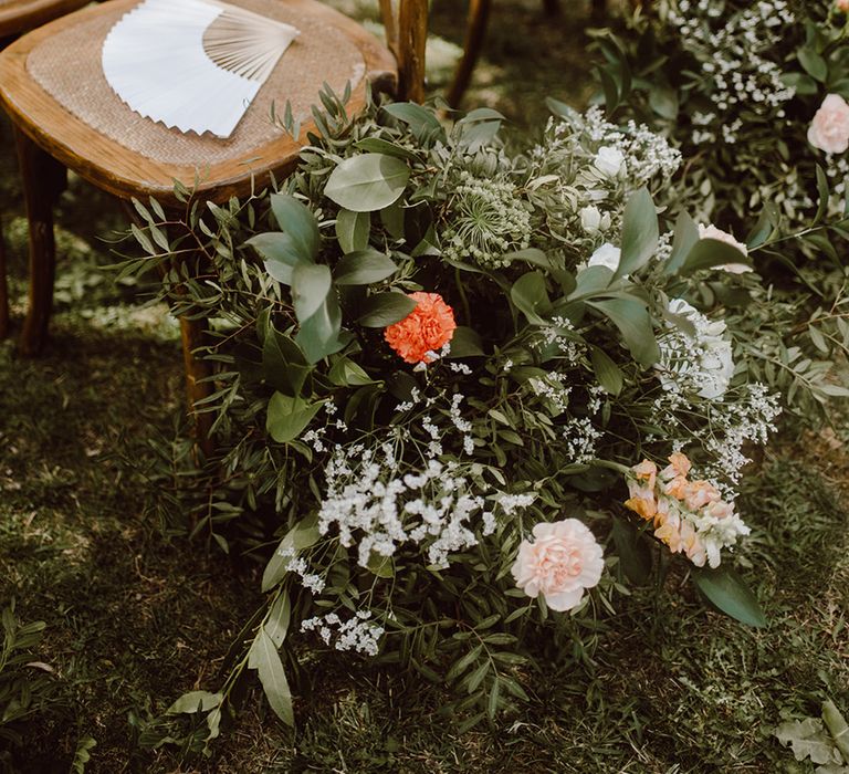 Wooden chairs with fans for guests