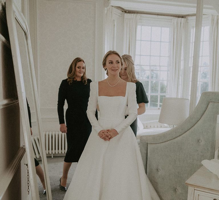 Bride in square neck, full skirt long wedding dress and pearl necklace at Hedsor House wedding