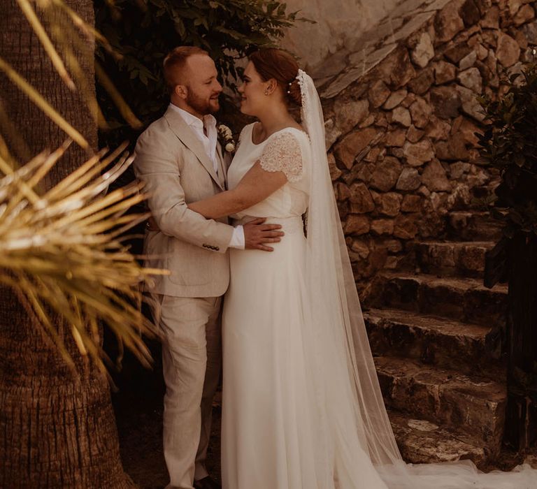 Bride & groom stand outdoors in Spain after relaxed and intimate ceremony 