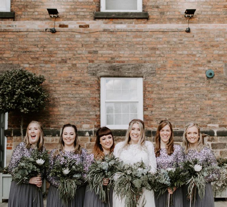 Dark grey bridesmaid dresses with sequin detailing on the top half of the dresses